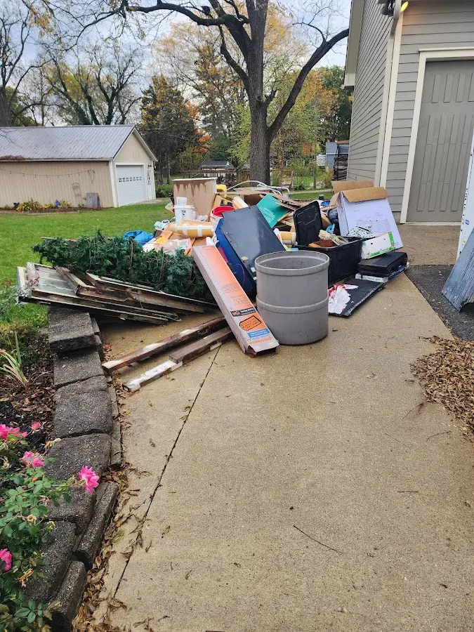 Dumpster being loaded with debris for Estate Cleanout Dumpster Rental in Lawrenceville